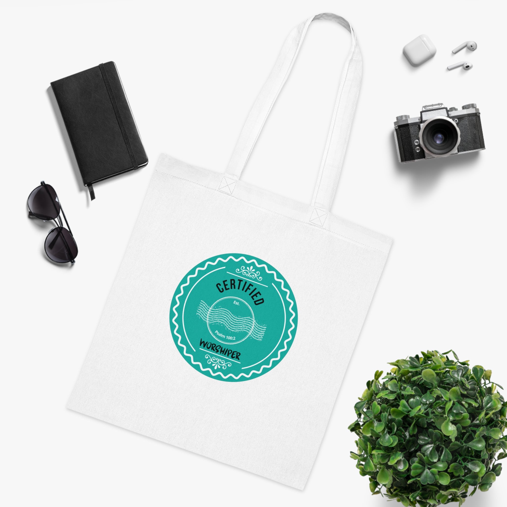 White tote bag with a green logo on a white background