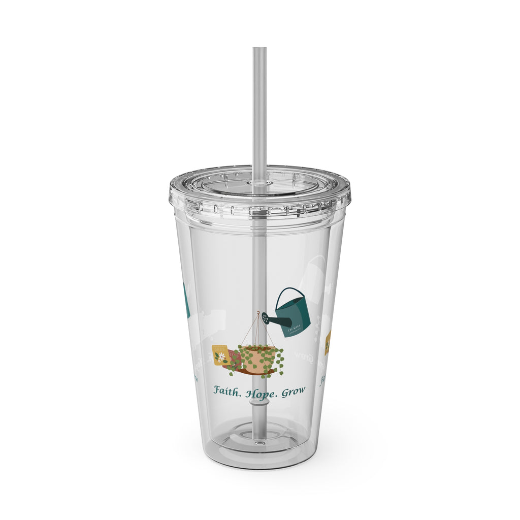 Clear tumbler with a straw and decorative elements on a white background