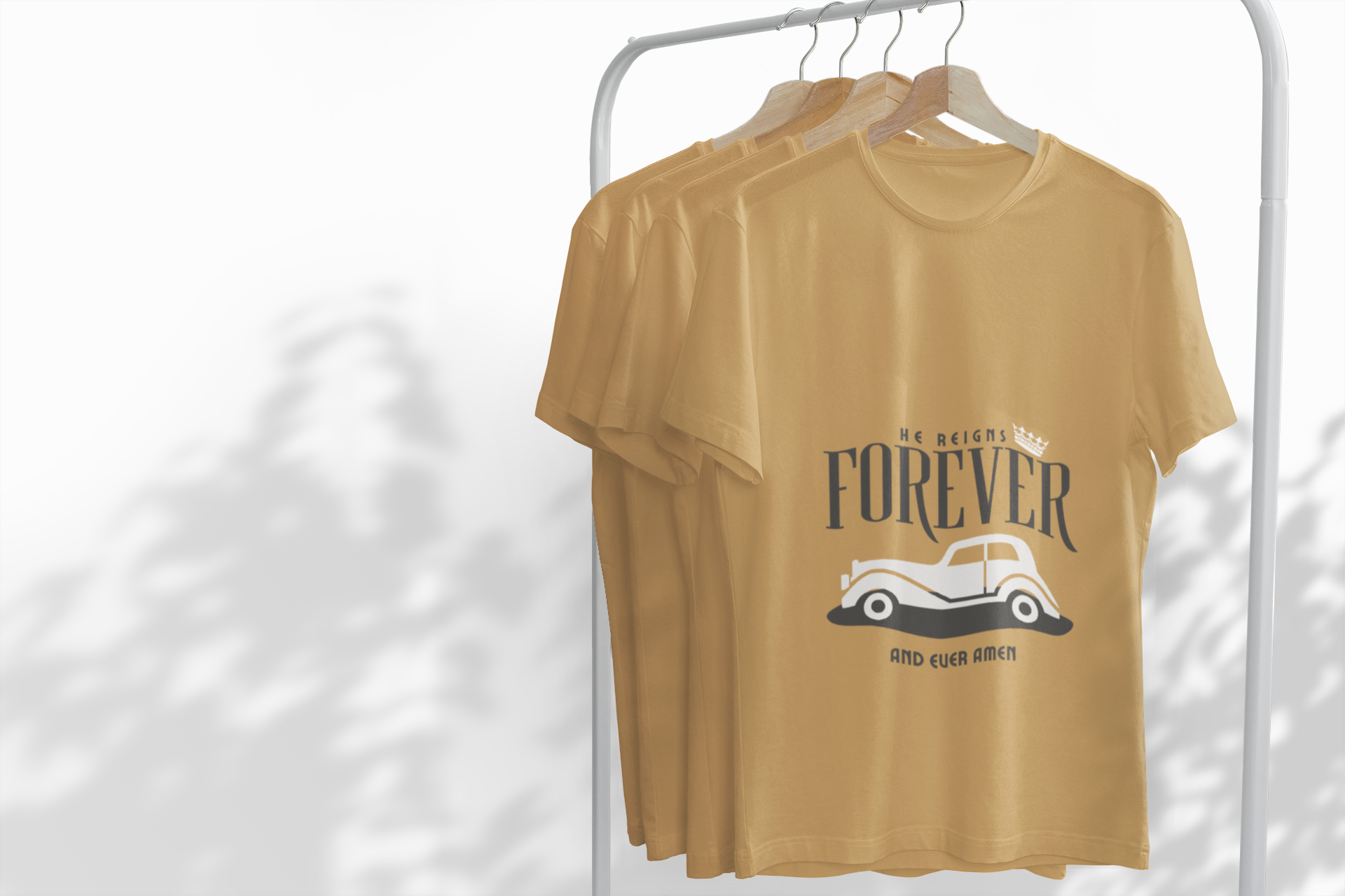 Mustard yellow t-shirt with graphic design on a white rack