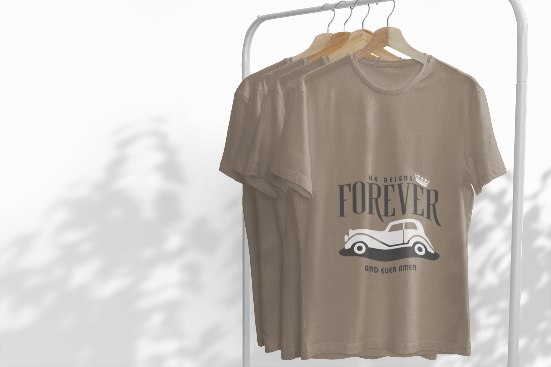 Brown t-shirt with graphic design on a hanger against a white background