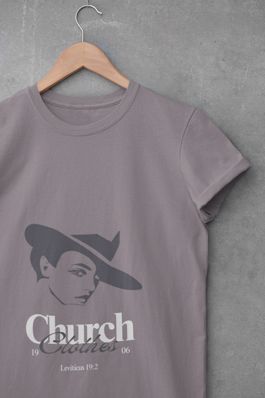 purple t-shirt with a graphic design on a hanger against a gray background