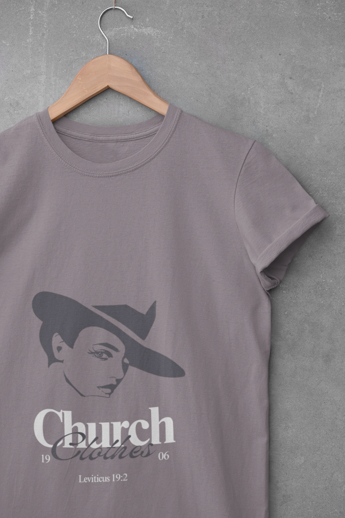 purple t-shirt with a graphic design on a hanger against a gray background