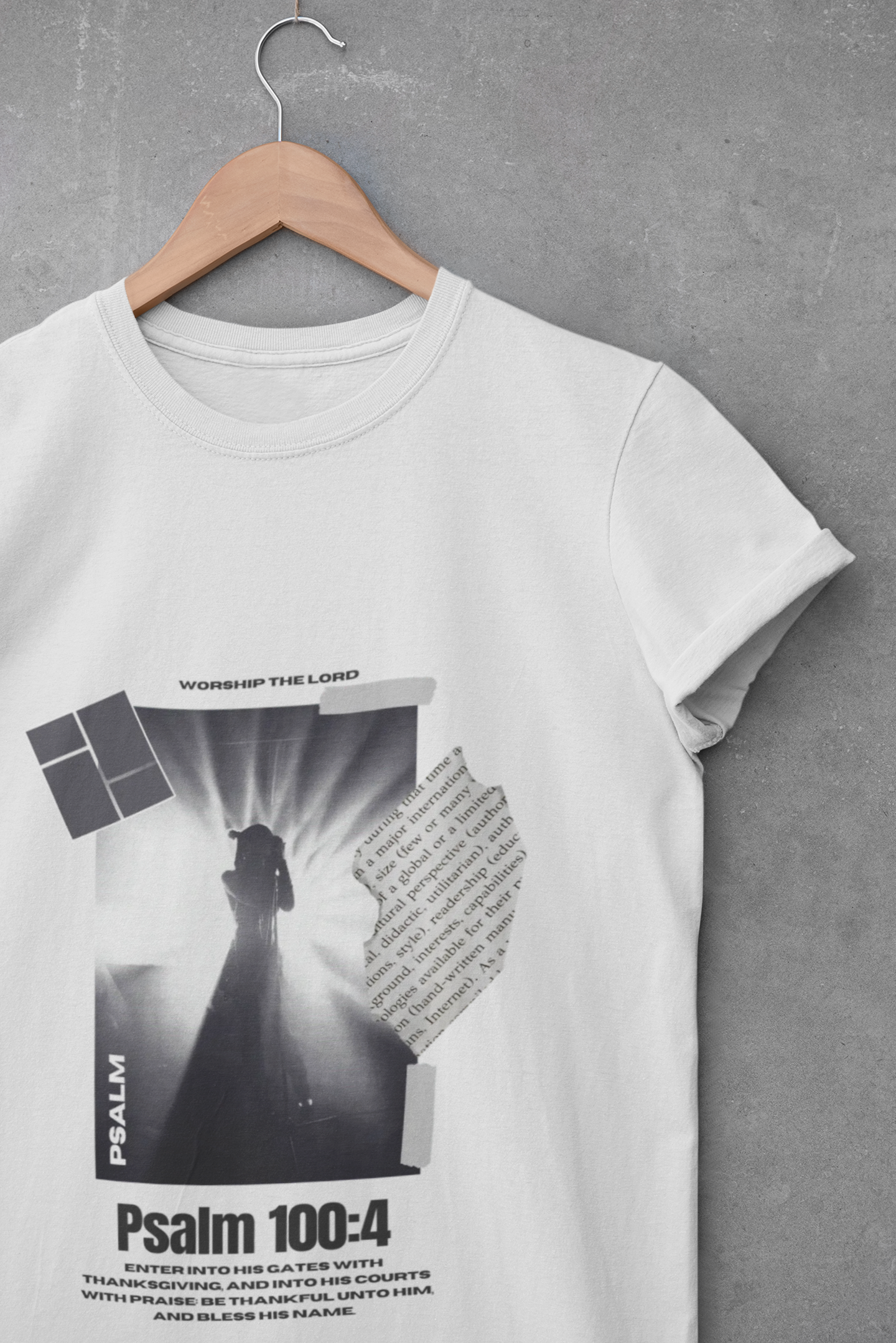 ash, White t-shirt with black and white graphic design on a hanger against a gray background