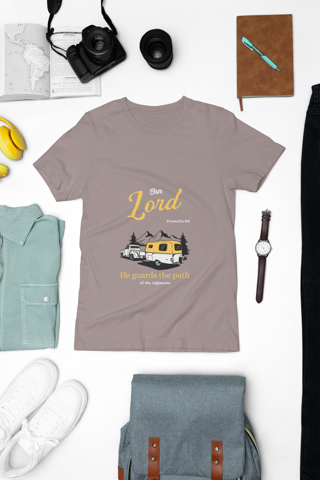 brown  t-shirt with graphic design on a white background with accessories around