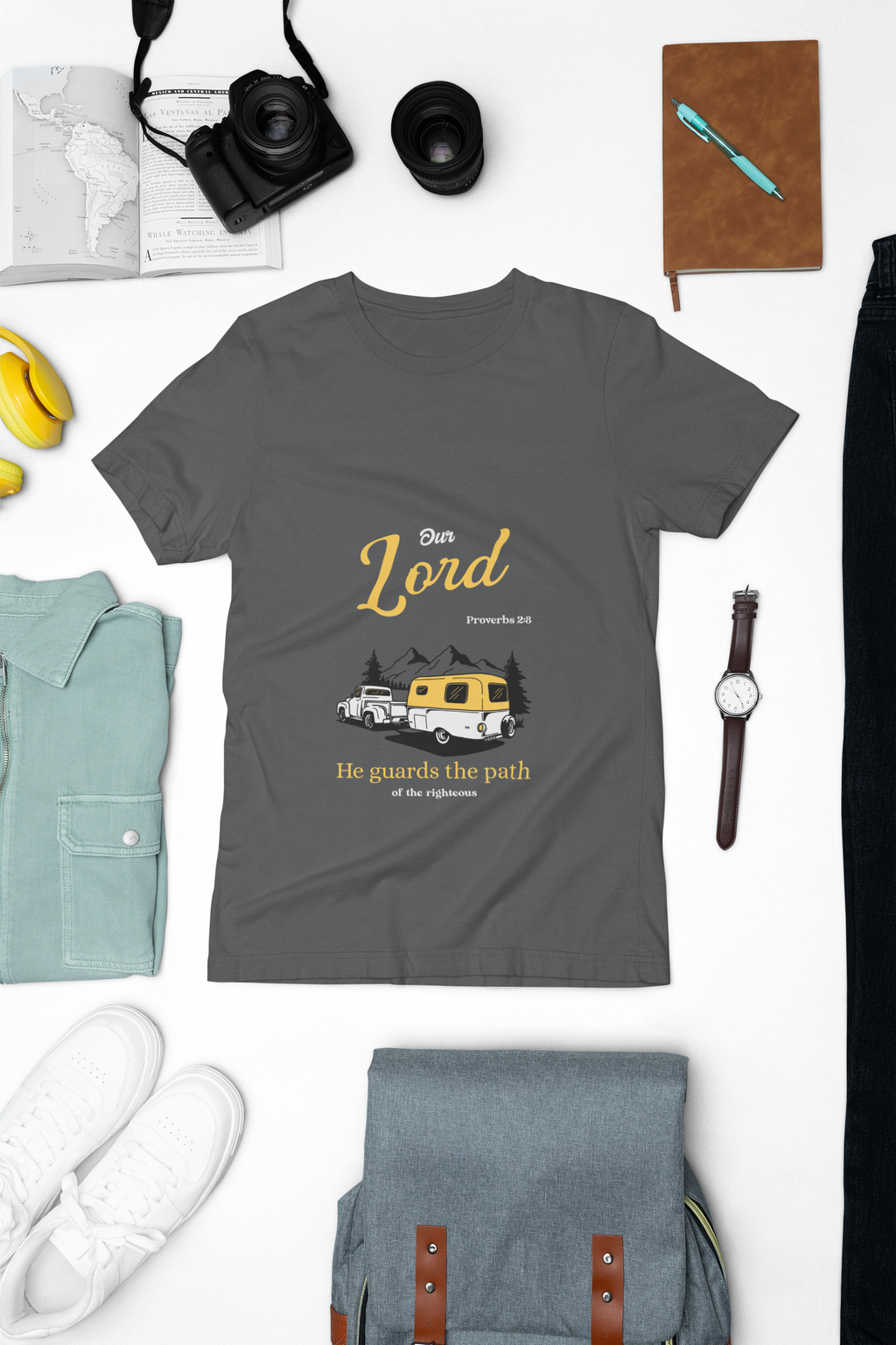 dark Gray t-shirt with graphic design and text on a white background with accessories around