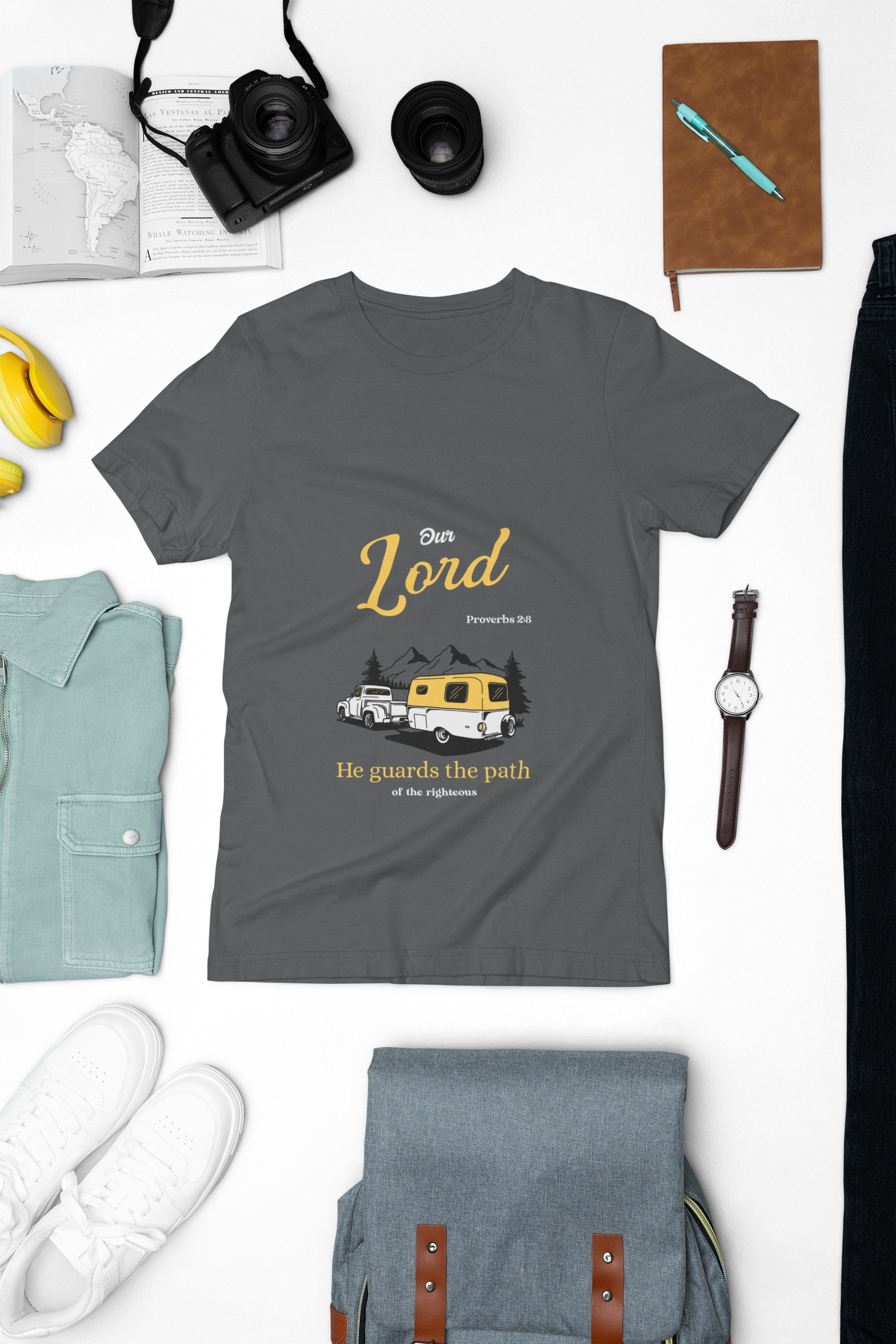 dark Gray t-shirt with graphic design and text on a white background with accessories around