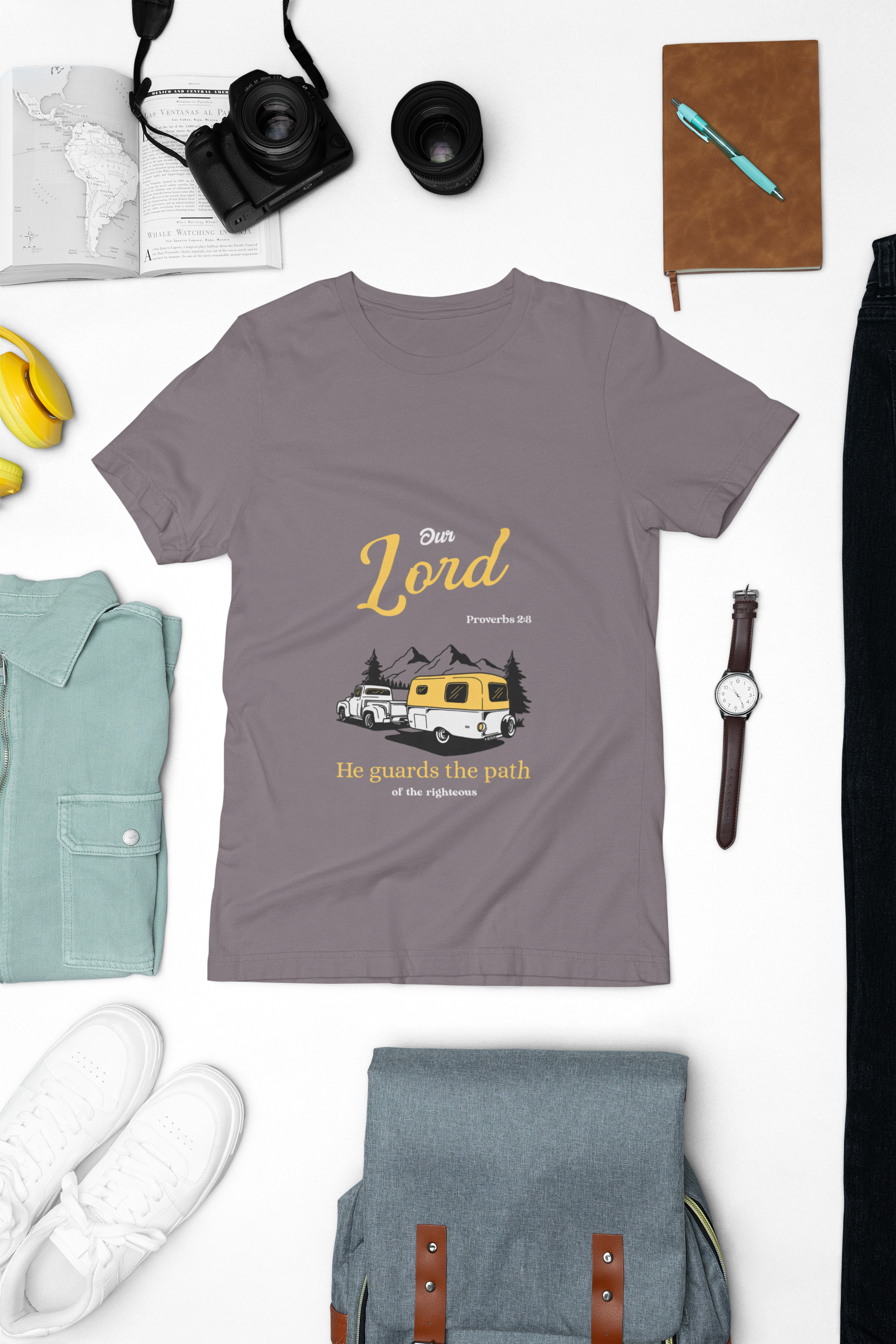 purple t-shirt with graphic design on a white surface with accessories around