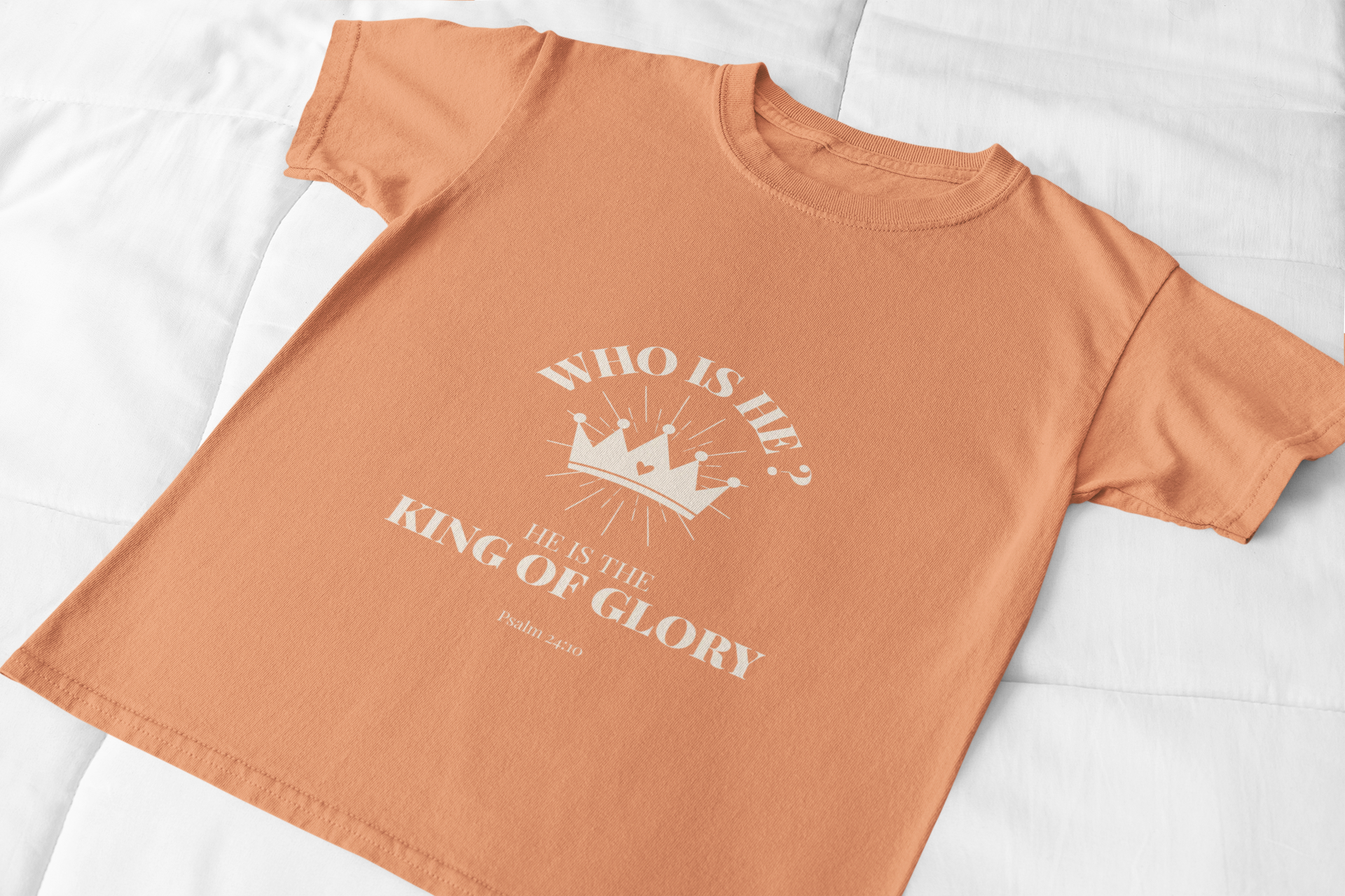 Orange t-shirt with white text and graphic on a white background