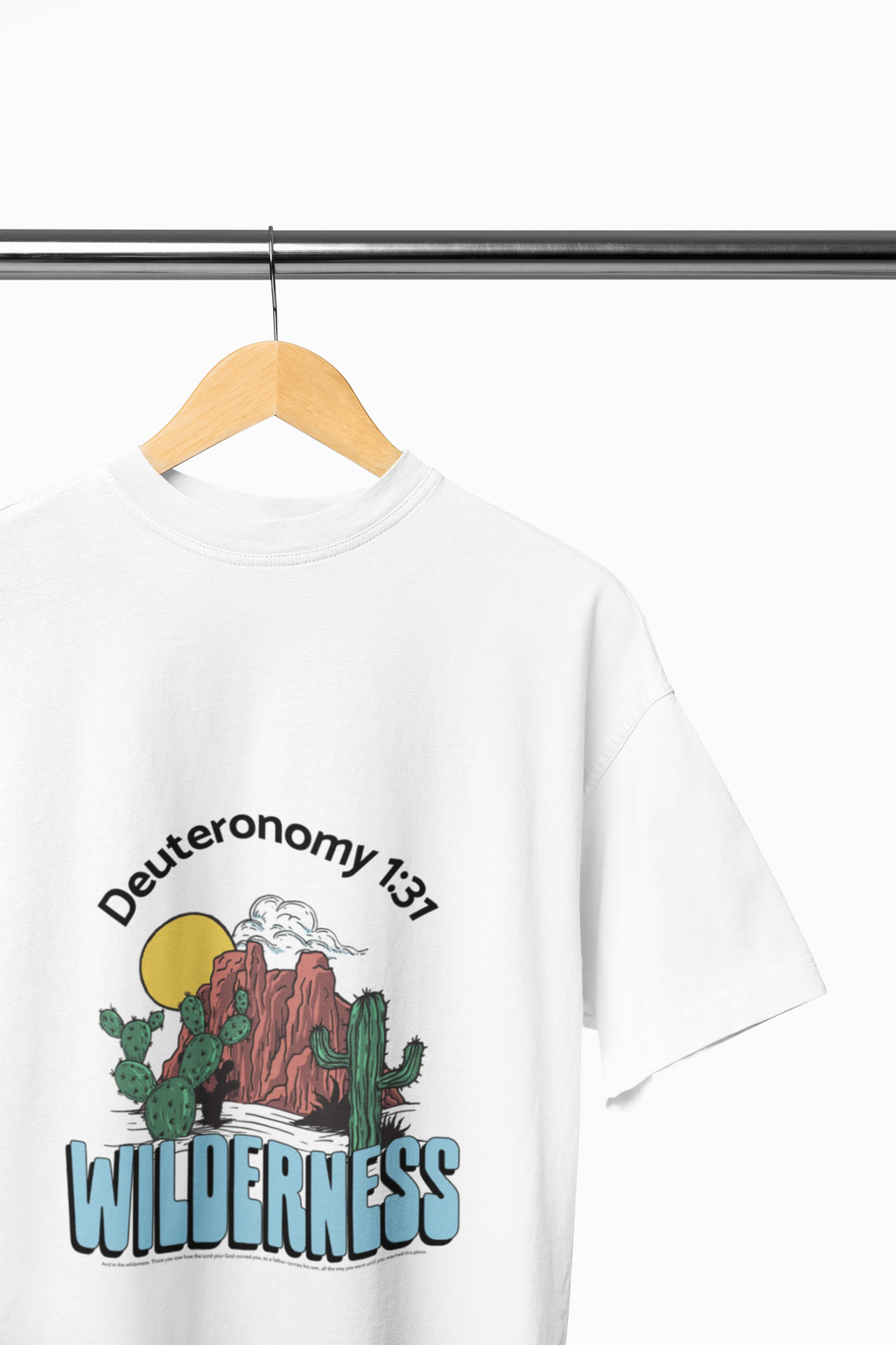 White t-shirt with desert-themed graphics and text on a hanger against a white background
