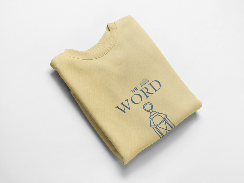 Folded yellow sweatshirt with 'The Word' text and design on a white background