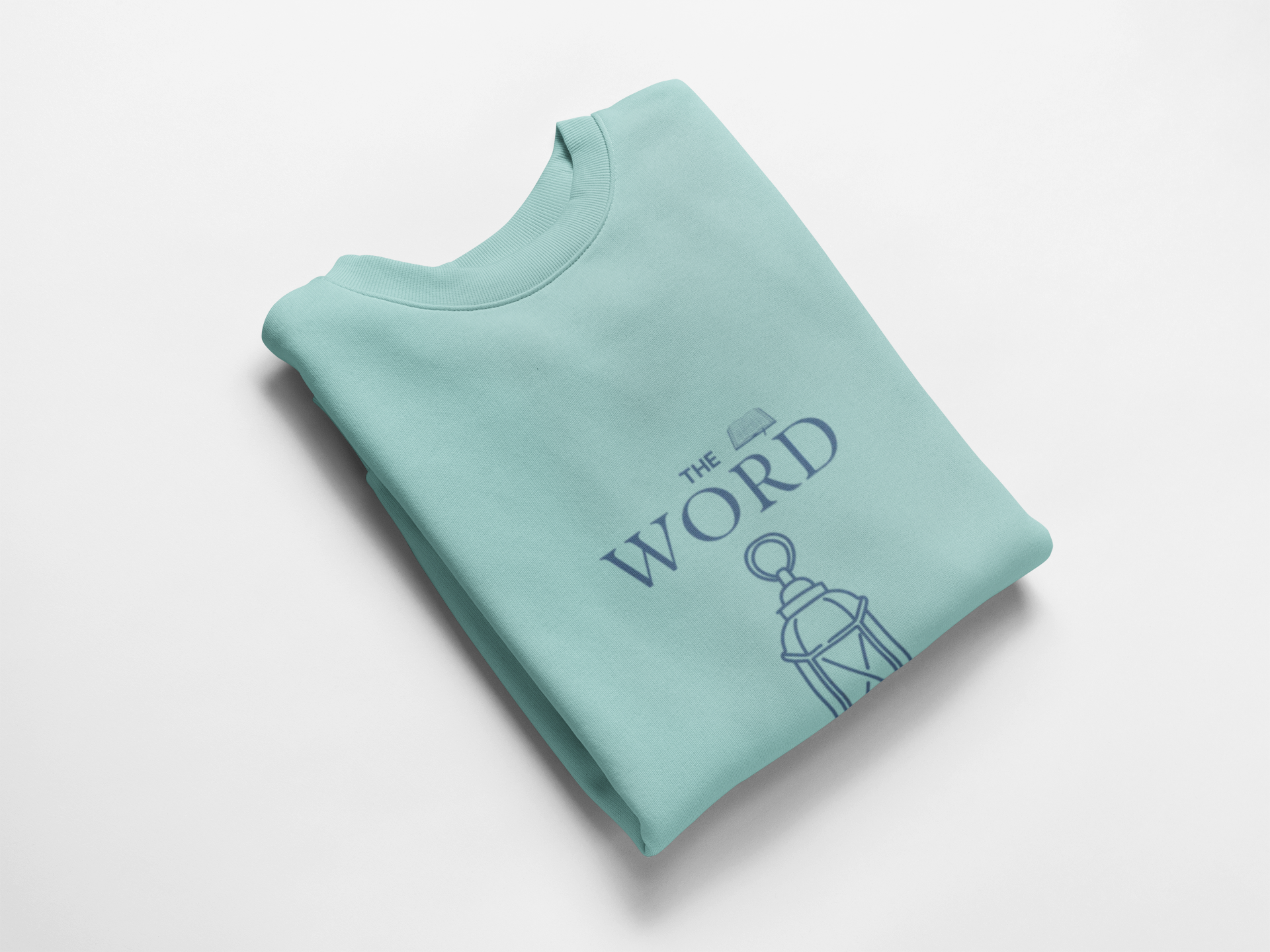 Folded light blue sweatshirt with 'The Word' text and graphic on a white background