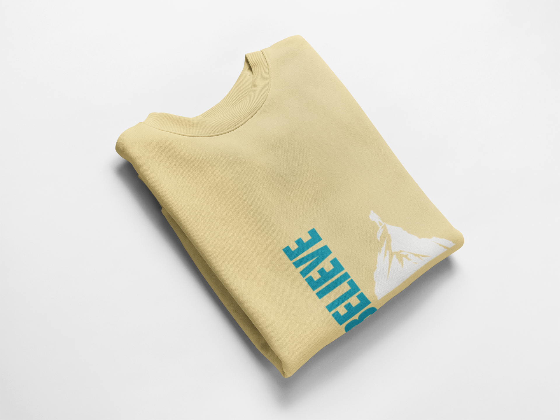 Folded yellow sweatshirt with blue and white graphics on a light gray background