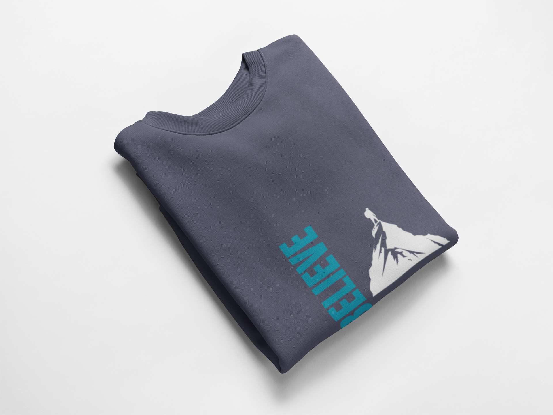 Folded denim blue sweatshirt with blue text and white graphic on a light gray background