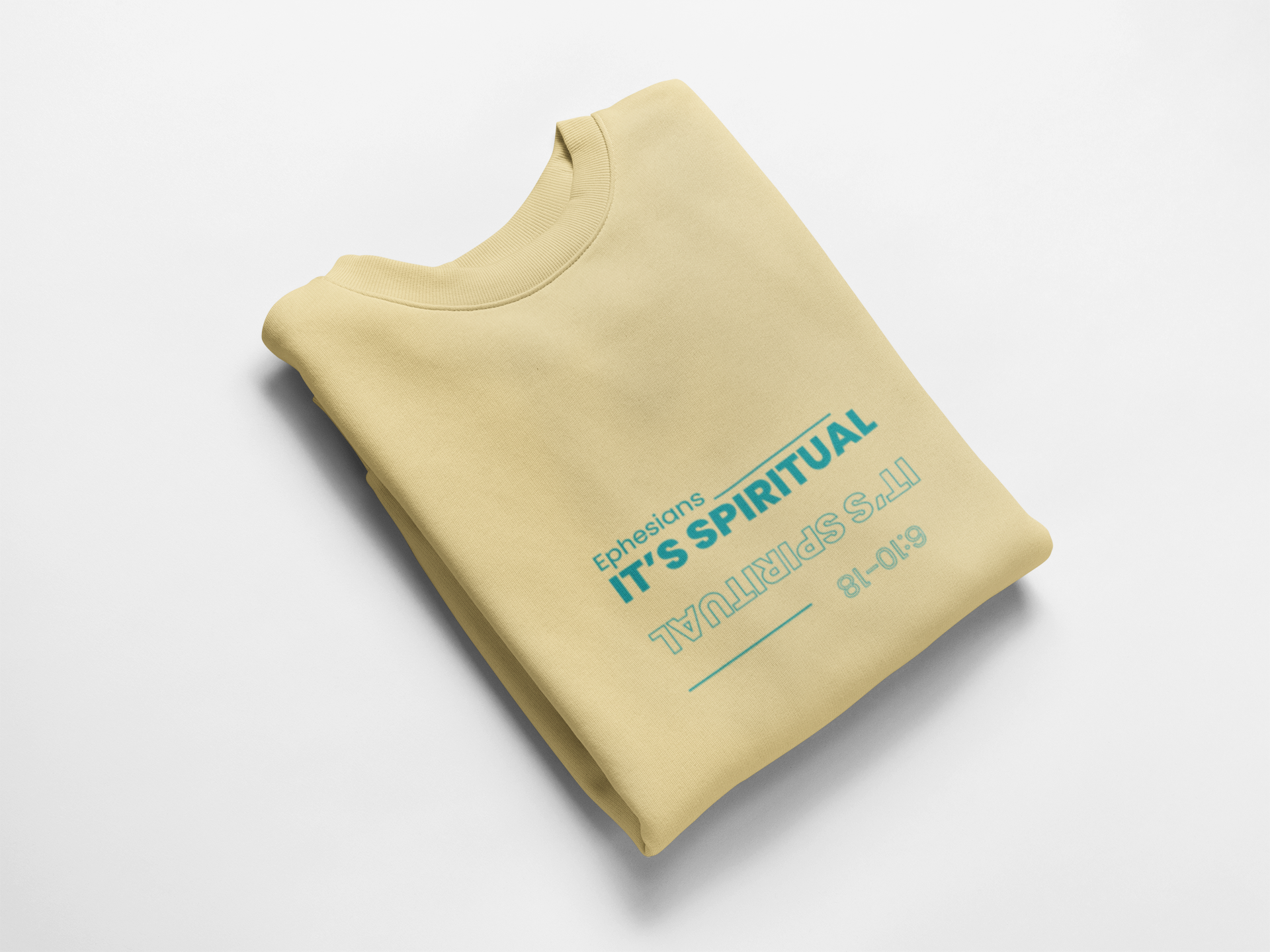 Folded yellow sweatshirt with teal text on a white background