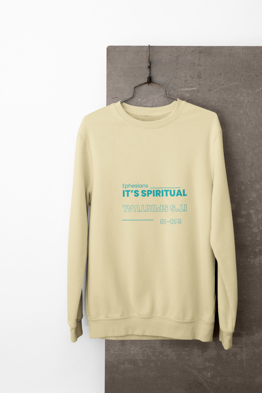 yellow sweatshirt with text on a gray surface