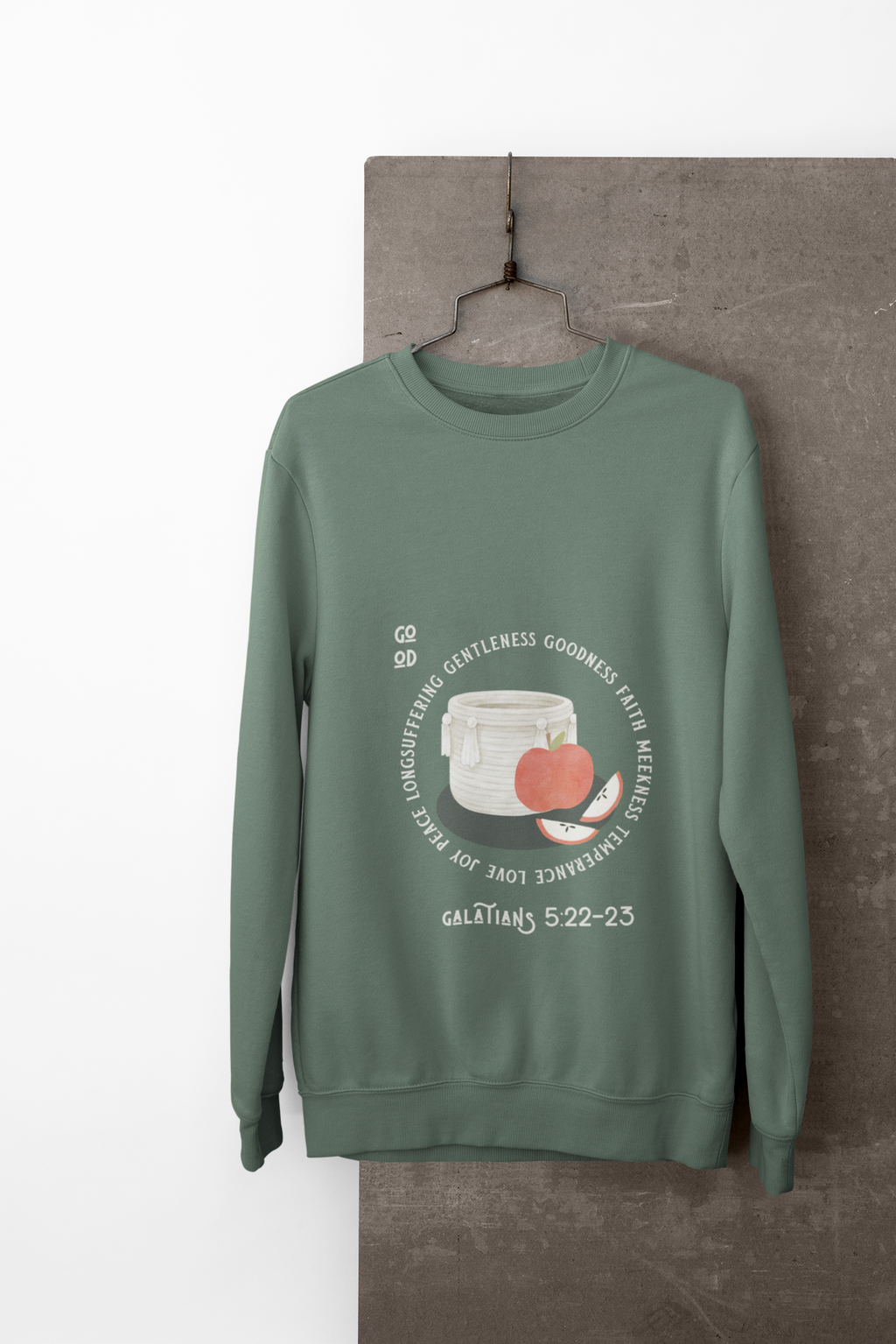 Green sweatshirt with a graphic design on a hanger against a white background