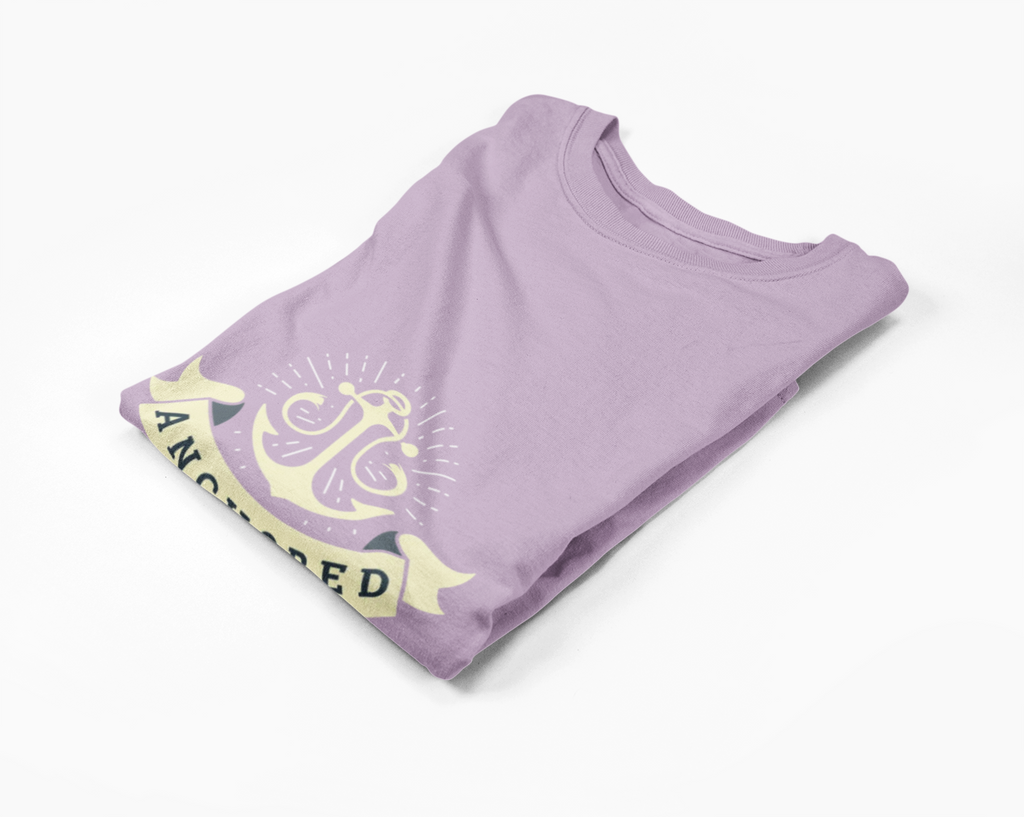 Folded purple t-shirt with yellow graphic and text on a white background