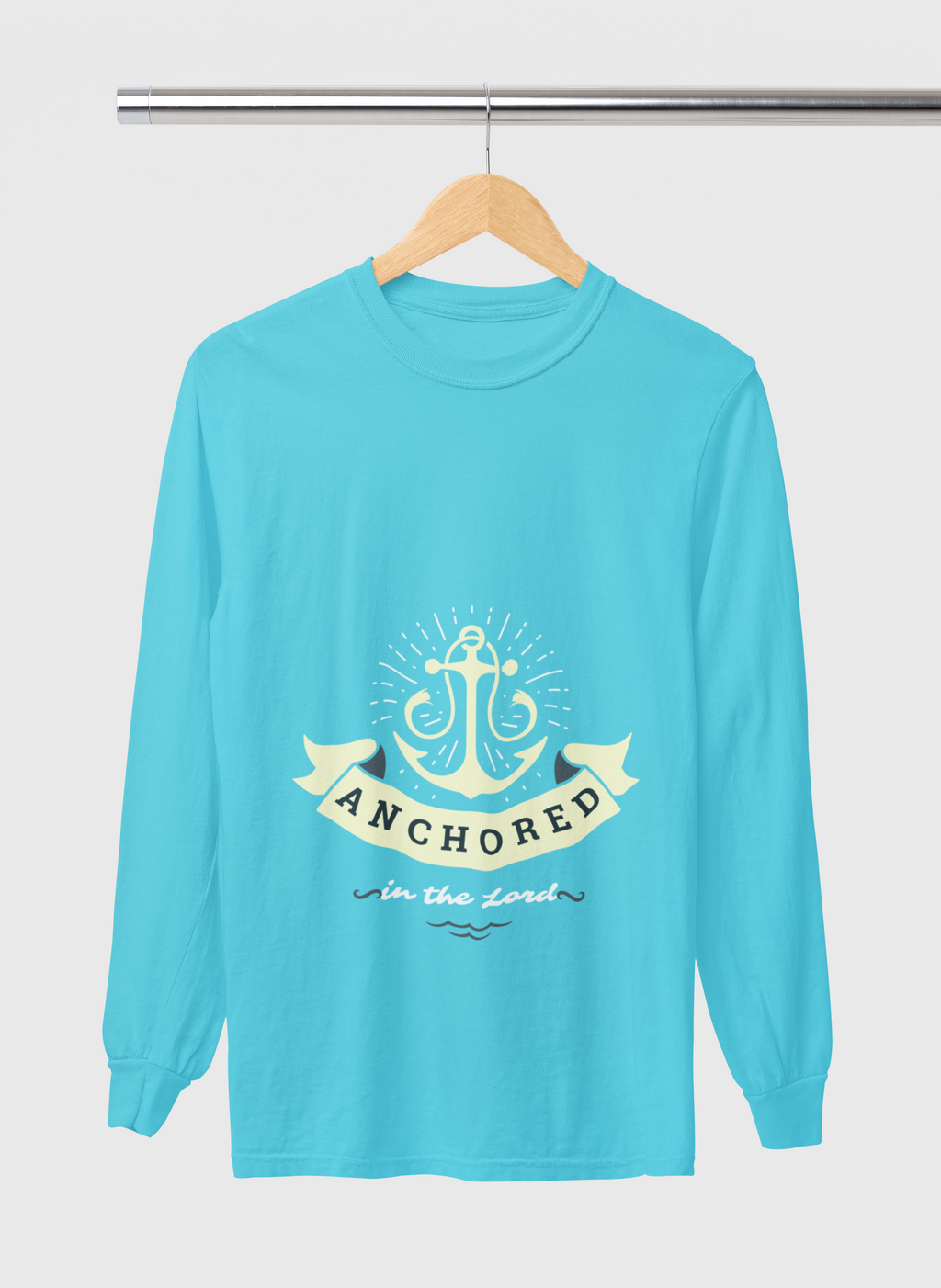Turquoise long-sleeve shirt with anchor design and text on a hanger against a white background