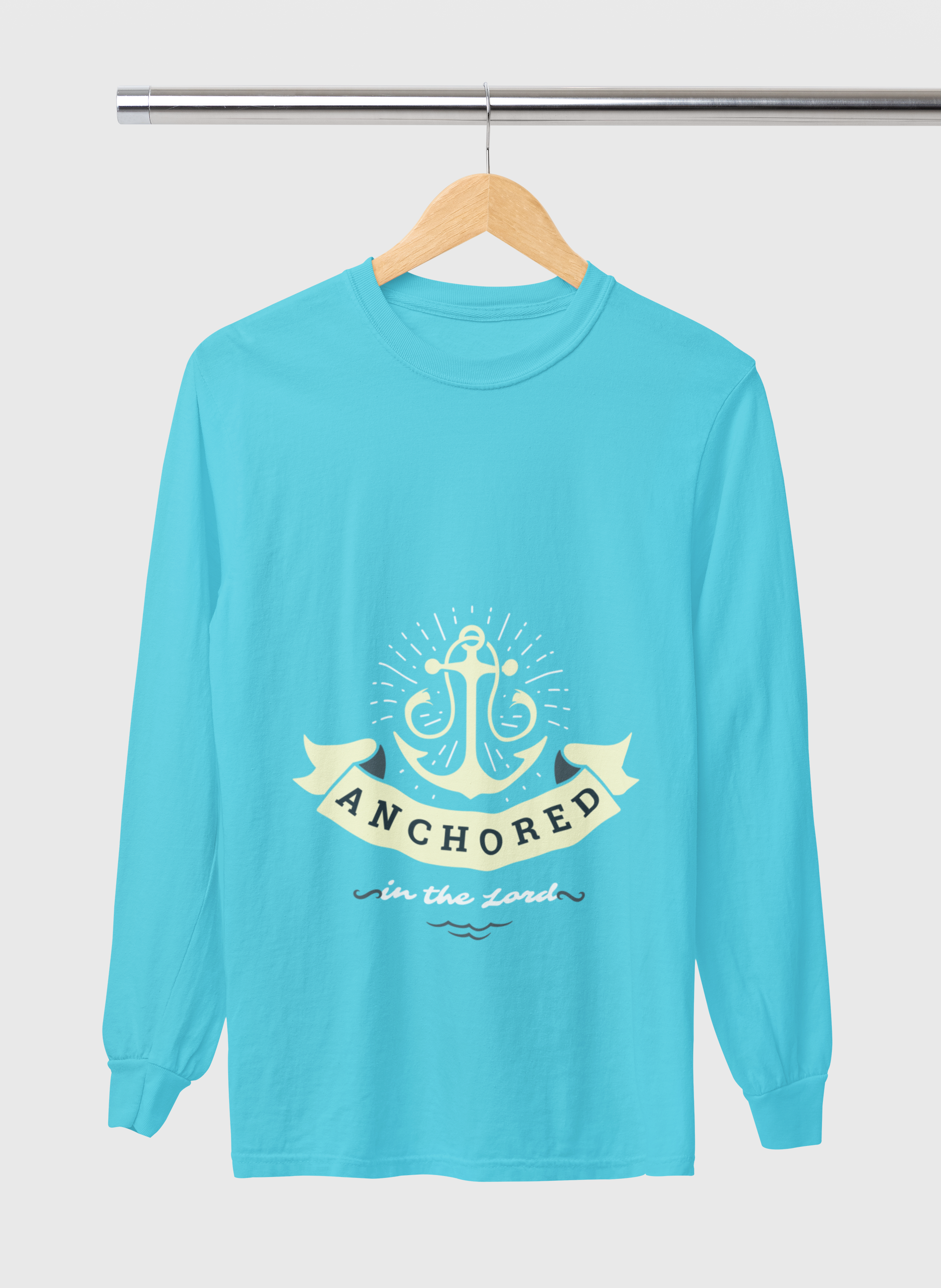 Turquoise long-sleeve shirt with anchor design and text on a hanger against a white background