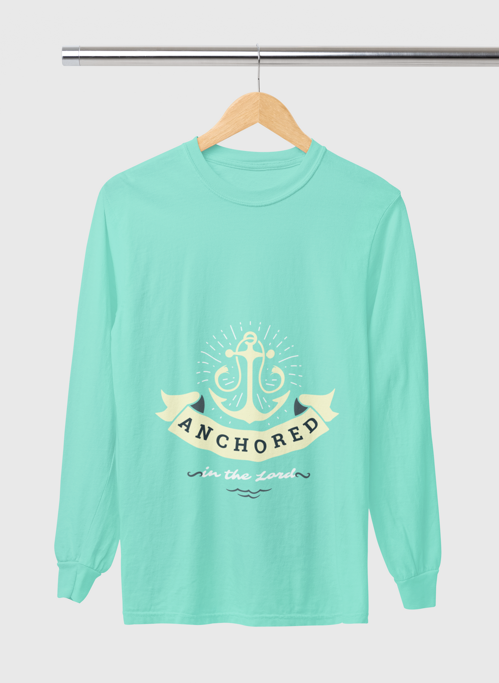 Mint green long-sleeve shirt with anchor design and text on a hanger against a white background
