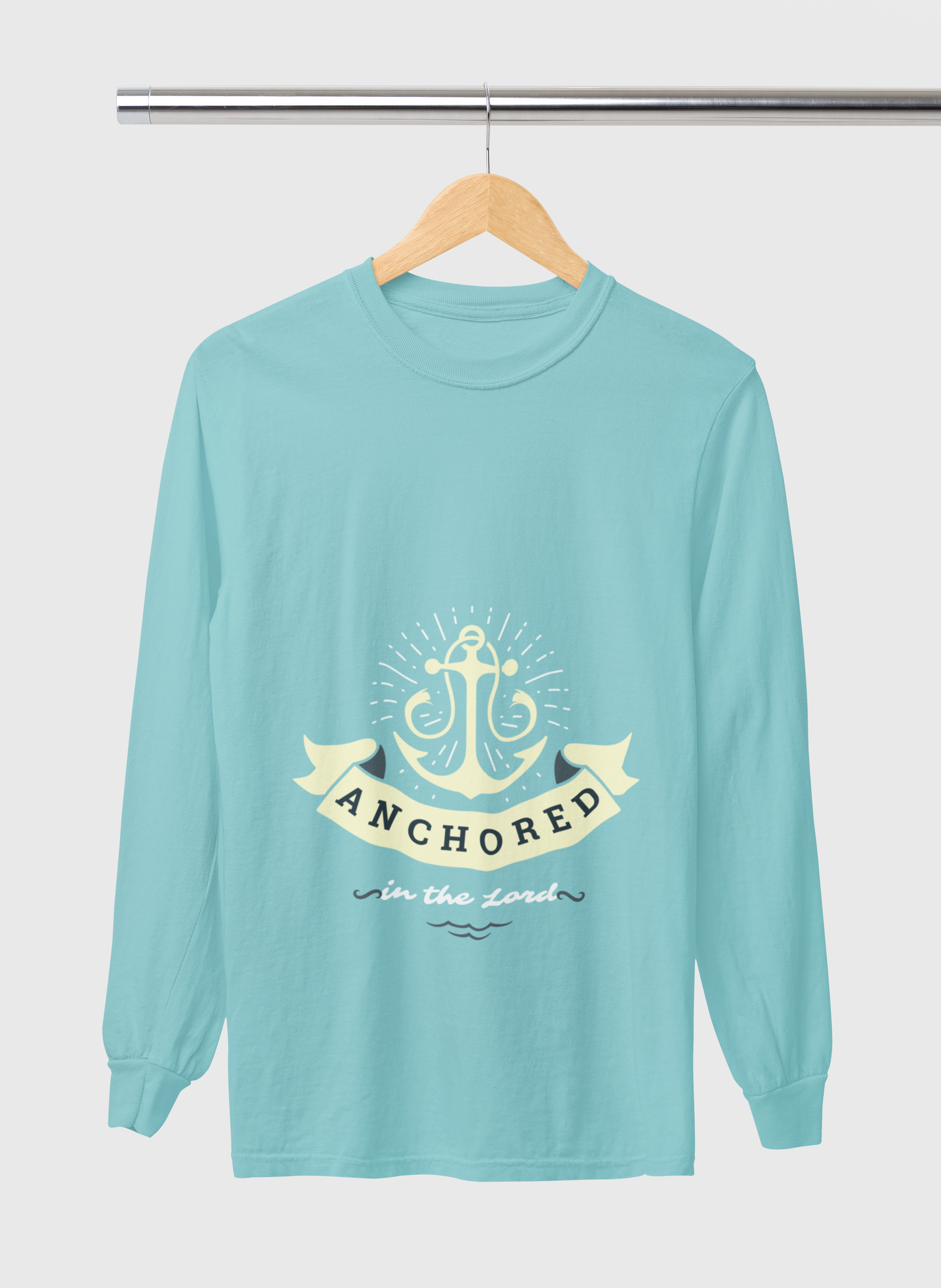 Teal long-sleeve shirt with anchor design and text on a hanger against a light gray background