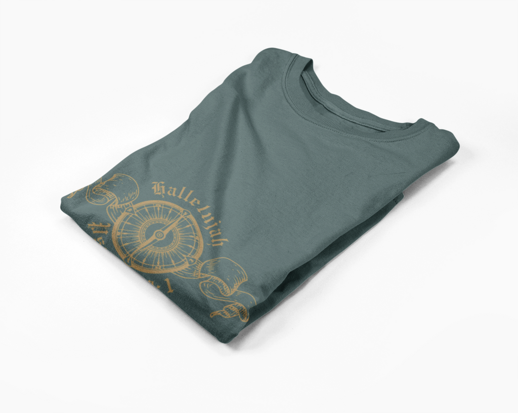 Folded green long-sleeve tee with gold compass design on a white background