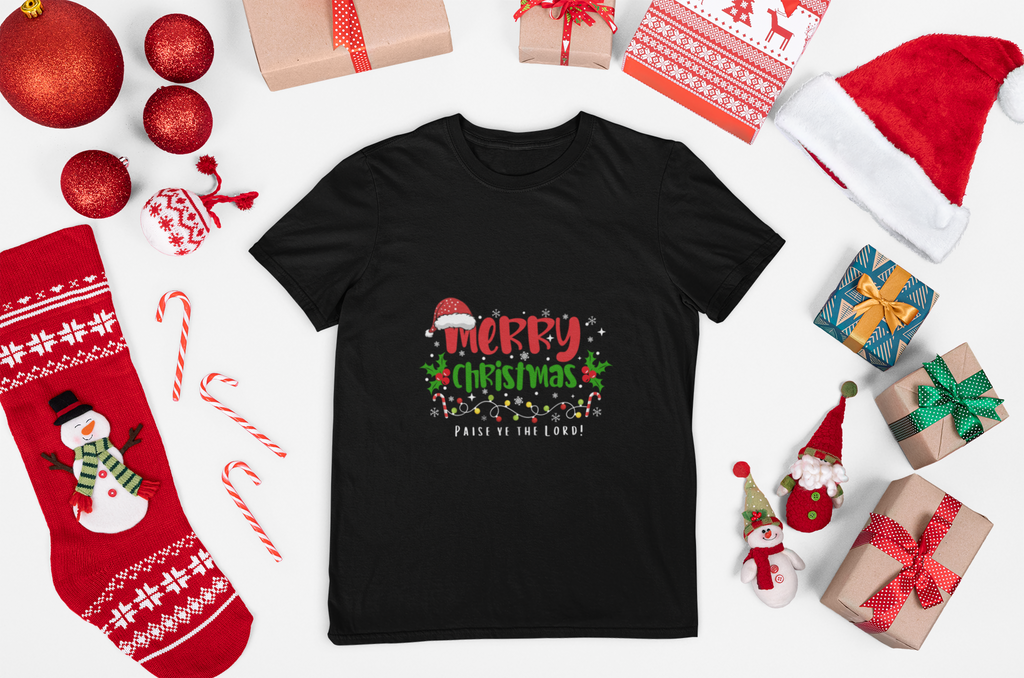 Black t-shirt with Christmas-themed design surrounded by festive items on a white background