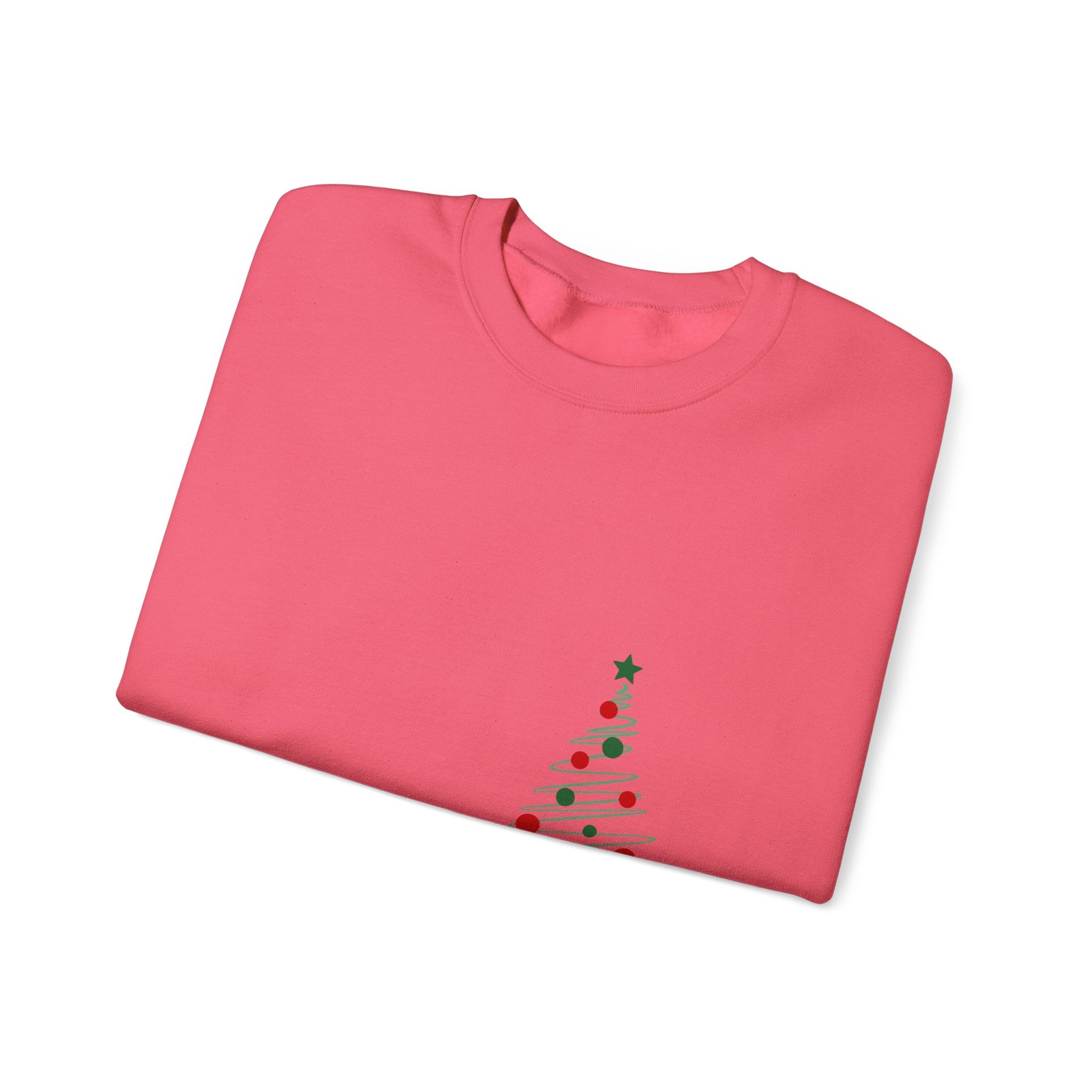 Folded pink shirt with a Christmas tree design on a white background