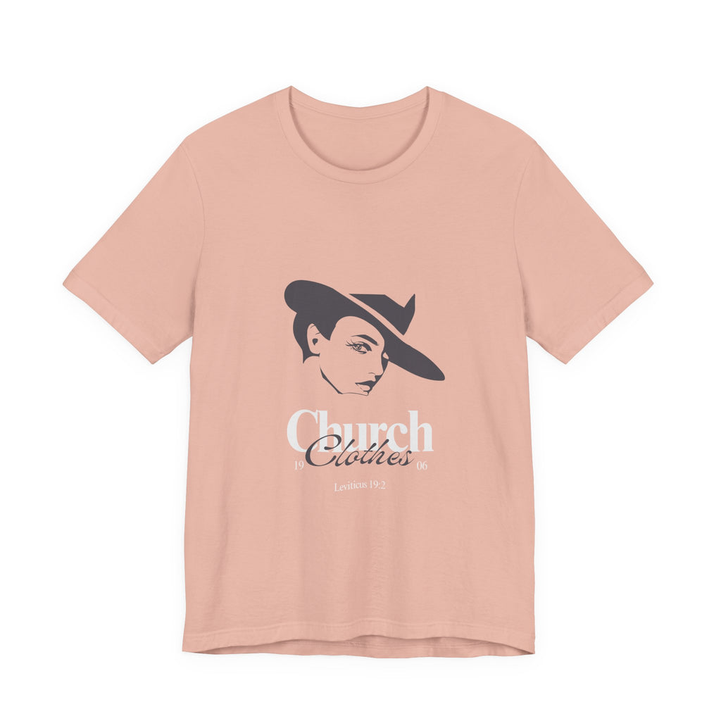 Peach t-shirt with a graphic of a woman wearing a hat and text on a white background