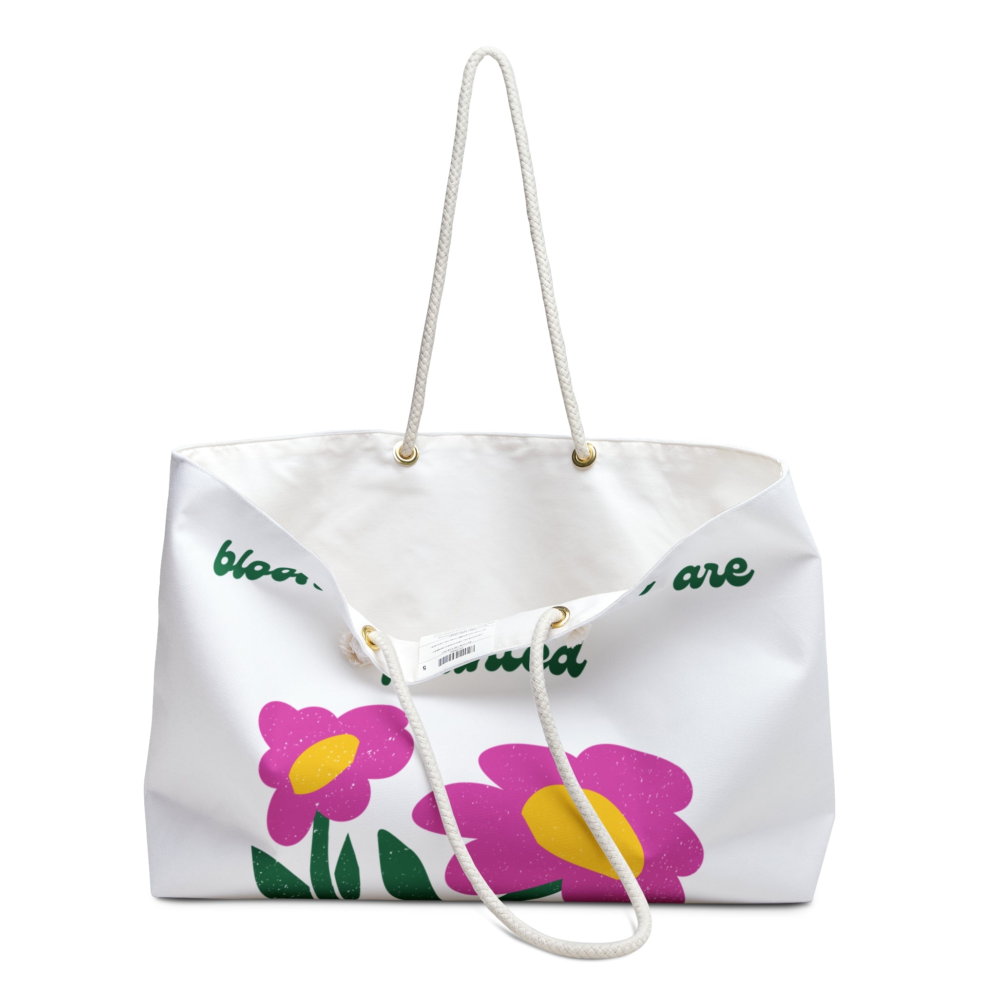 opening of White tote bag with pink flowers and green text on a white background