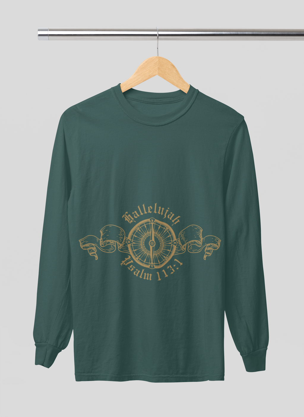 Green long-sleeve shirt with gold design on a hanger against a gray background