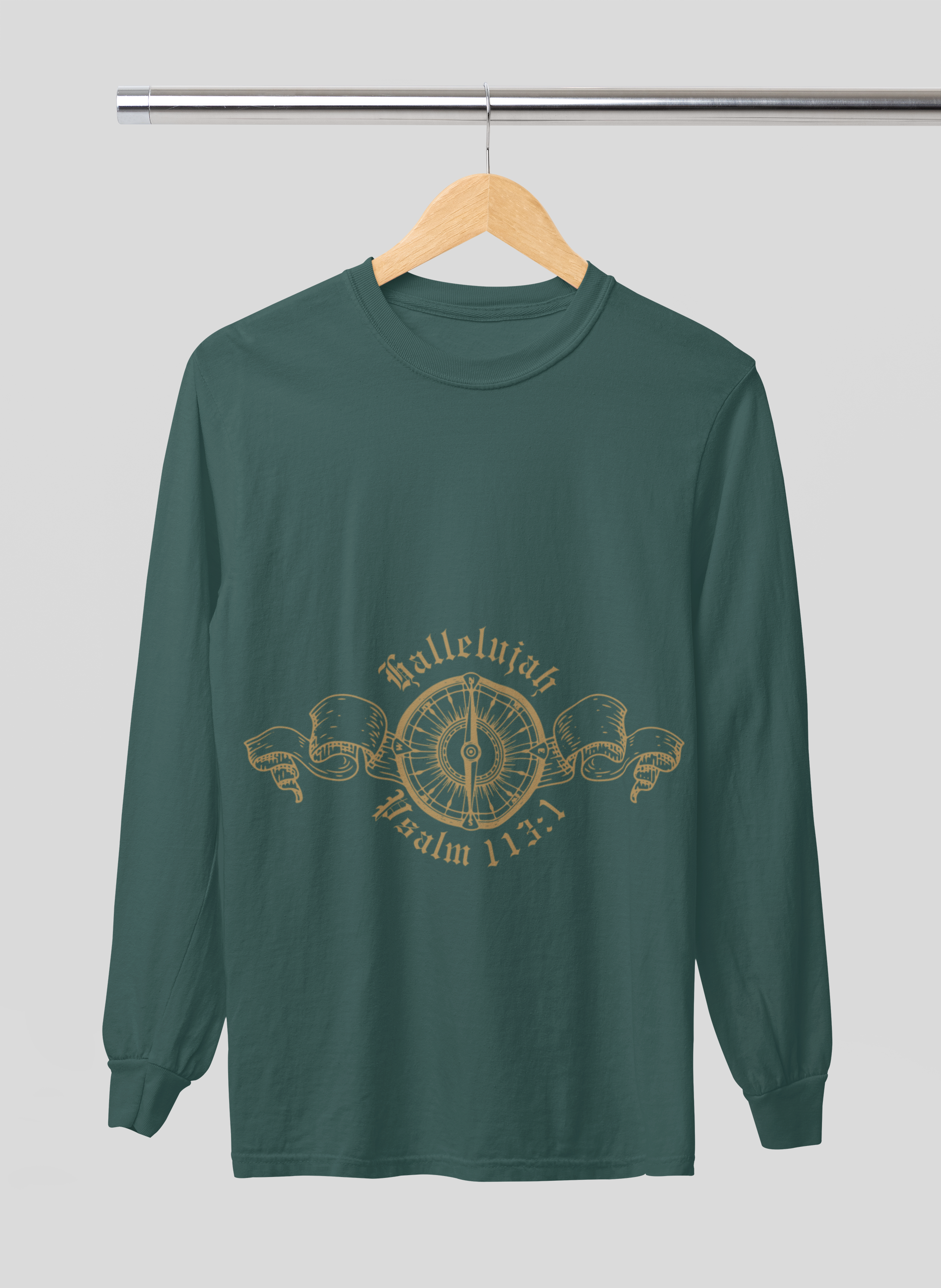 Green long-sleeve shirt with gold design on a hanger against a gray background