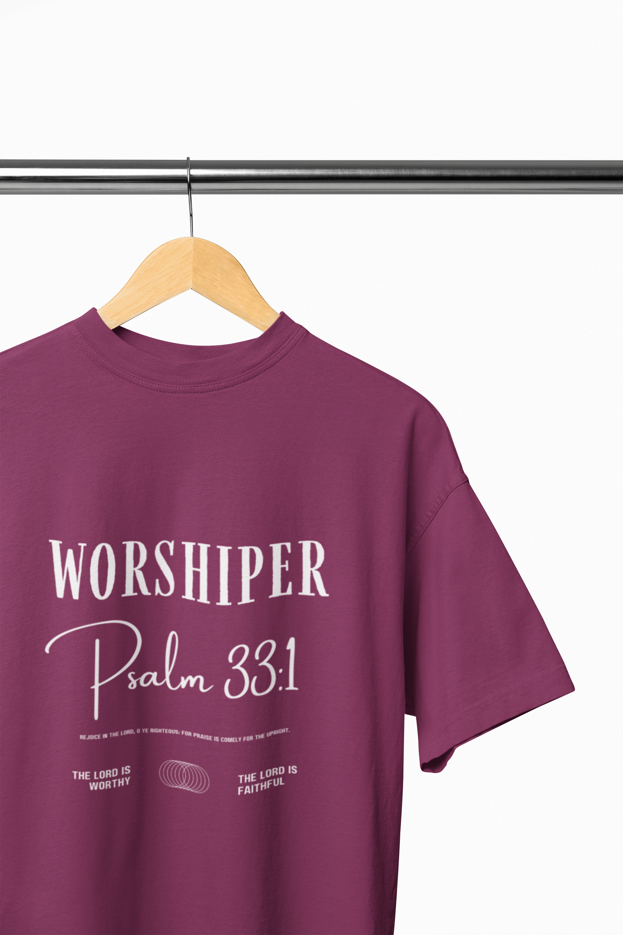 Purple t-shirt with 'Worshiper Psalm 33:1' text on a hanger against a white background