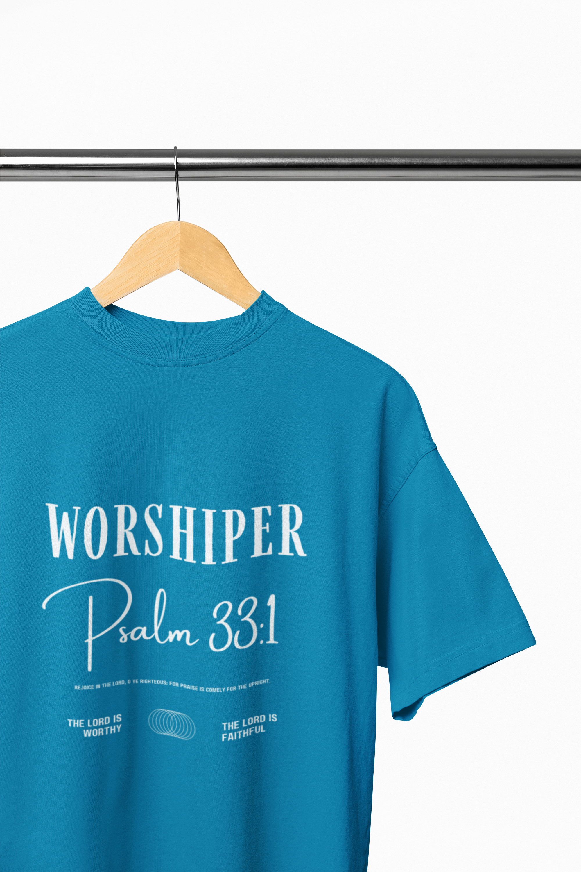 Blue t-shirt with 'Worshiper Psalm 33:1' text on a hanger against a white background