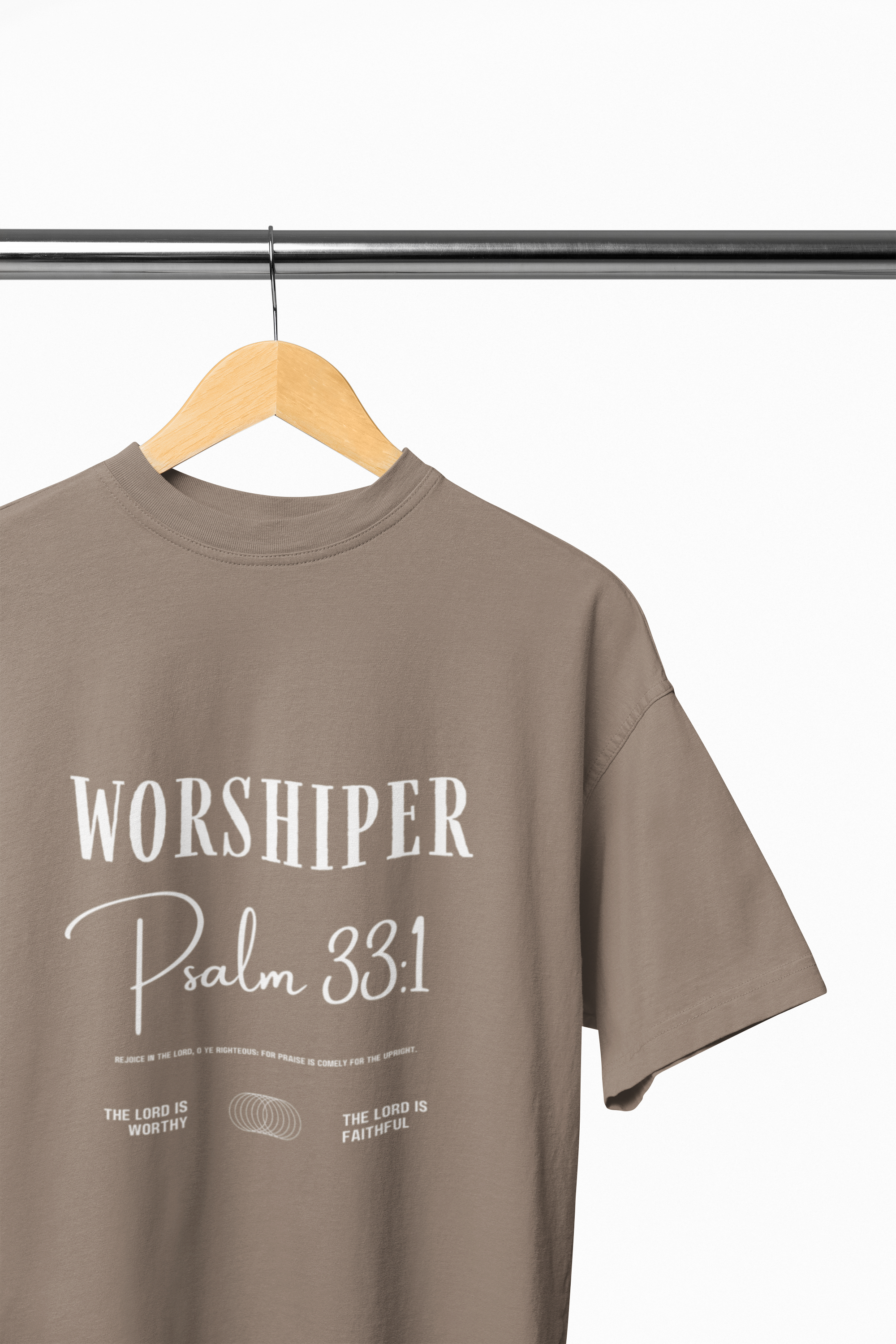 Brown t-shirt with 'Worshiper Psalm 33:1' text on a hanger against a white background