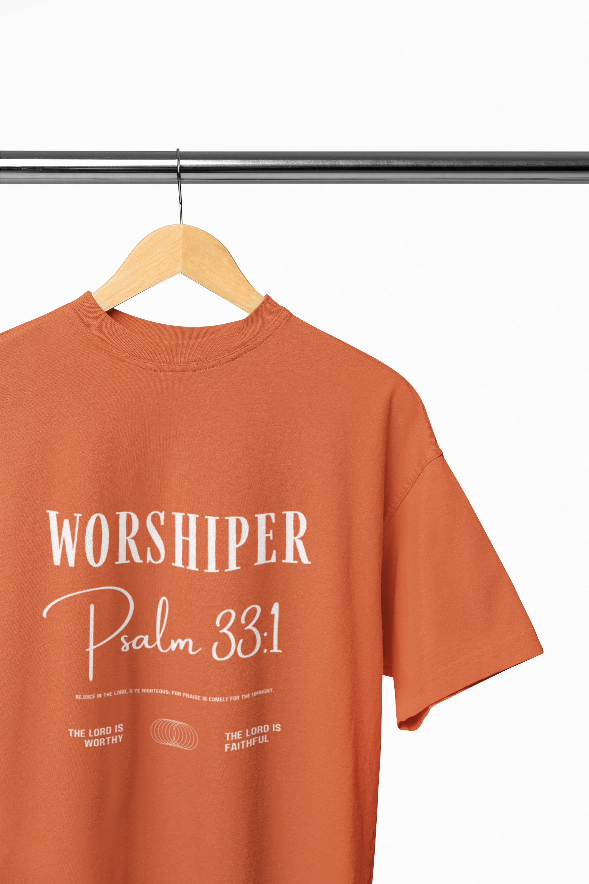 orange t-shirt with 'Worshiper Psalm 33:1' text on a hanger against a white background