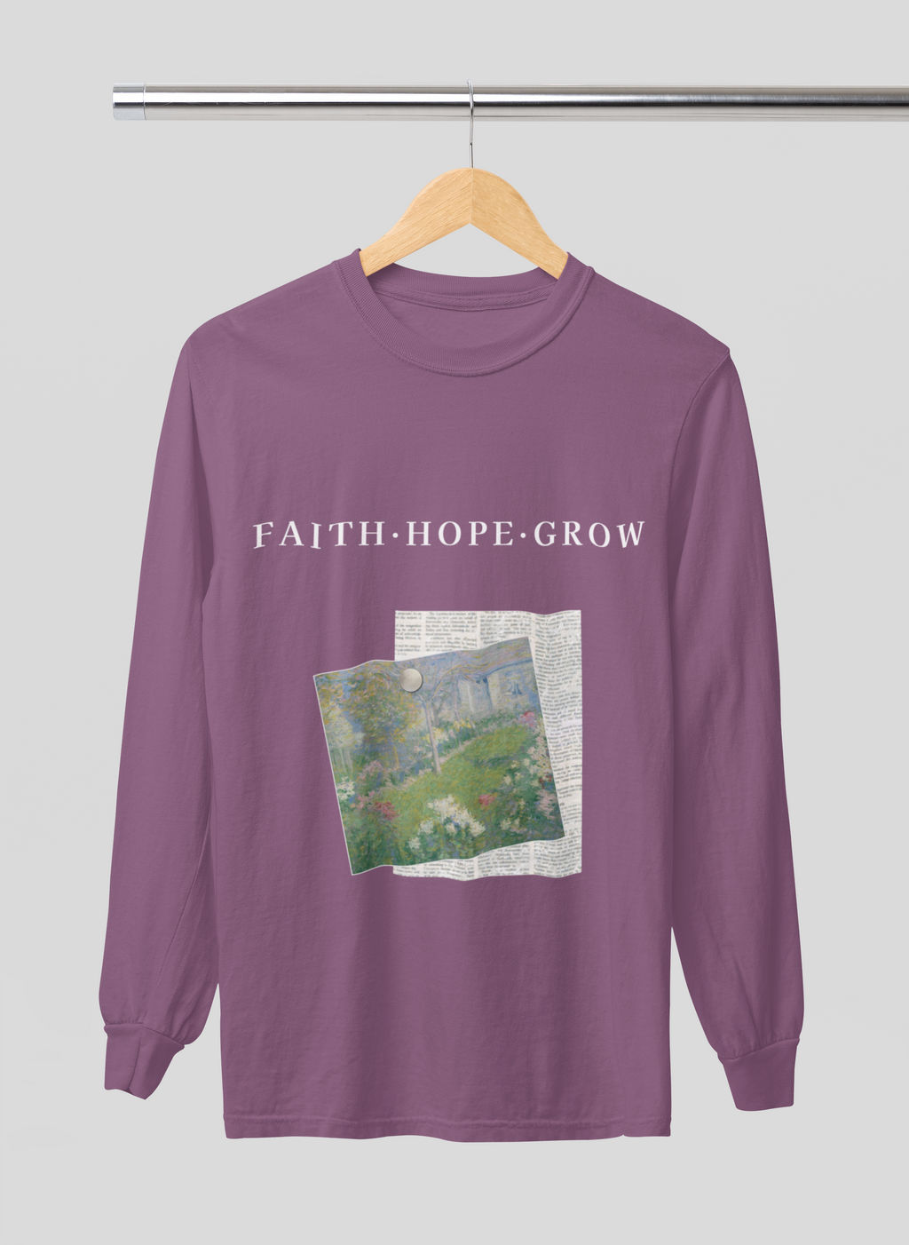 Purple long-sleeve shirt with 'FAITH HOPE GROW' text and nature graphic on a hanger.